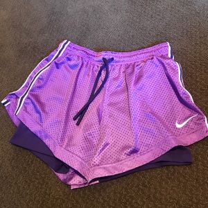 Purple dri-fit Nike combat shorts.